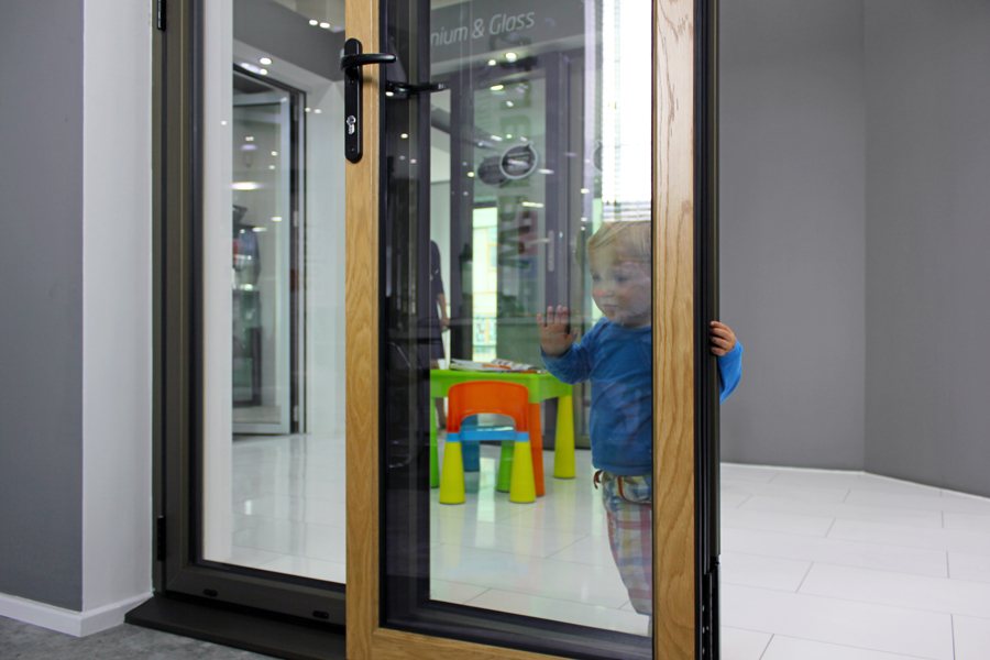 Showroom child playing, hardwood timber and aluminum bi-fold doors